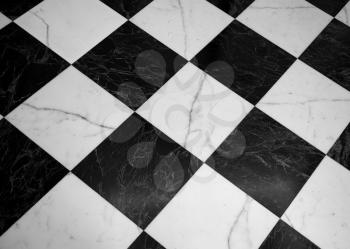 vintage black and white marble checkered floor useful as a background