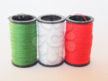 Sewing kit including thread spools of three different colours in the shape of the Italian flag