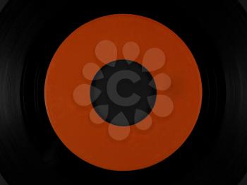Single 45 rpm vinyl on black rubber platter mat for a phonograph turntable, with blank orange label