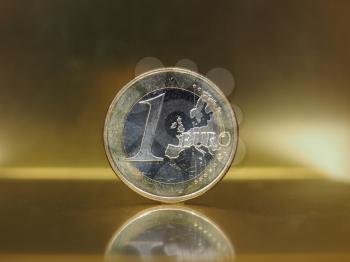 1 euro coin money (EUR), currency of European Union over golden background with reflection