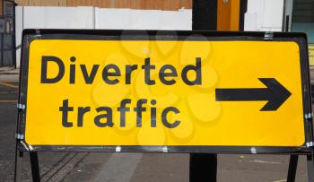 Diverted traffic direction sign, black text over yellow