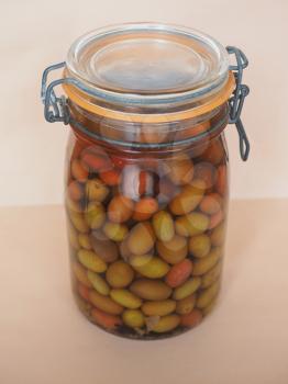 Olives (Olea europaea sylvestris) vegetables vegetarian food in brine in a glass jar
