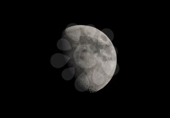 Gibbous moon over dark black sky seen with a telescope from northern emisphere at night