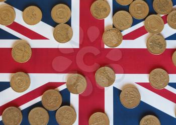 Pound coins money (GBP), currency of United Kingdom, over the Union Jack