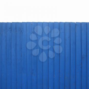 A blue wooden fence over blue sky - isolated over white background