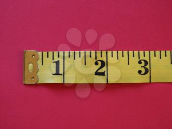 a ruler with Imperial units, over red background
