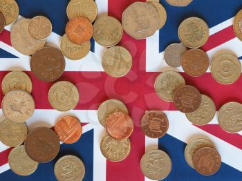 Pound coins money (GBP), currency of United Kingdom, over the Union Jack