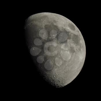 Gibbous moon over dark black sky seen with a telescope from northern emisphere at night