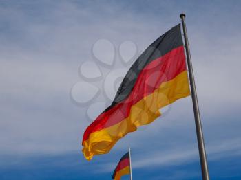 The national German flag of Germany over blue sky