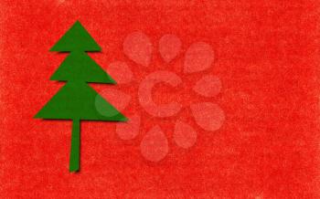 green christmas tree over red paper with copy space for greeting cards