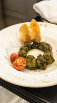 Dolma meat meal with tomato close up