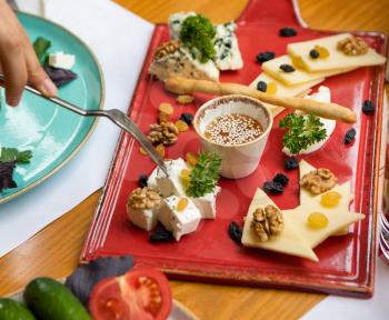 Cheese assorti on the red plate