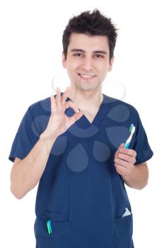 Royalty Free Photo of a Dentist Holding a Toothbrush