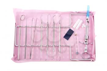 Royalty Free Photo of a Dentistry Kit on a Tray on a Pink Bib