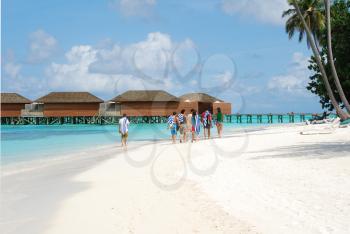 Royalty Free Photo of a Family Walking by the Beach in Maldives