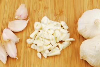 Royalty Free Photo of Garlic on a Chopping Board