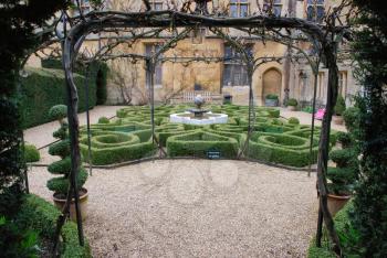 Royalty Free Photo of a Topiary Knot Garden and Fountain at Sudeley Castle in Winchcombe, Gloucestershire 