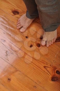 Royalty Free Photo of Bare Feet on a Wooden Floor