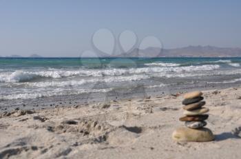 Royalty Free Clipart Image of a Pebble Stack on Kos Beach