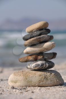 Royalty Free Clipart Image of a Pebble Stack on Kos Beach