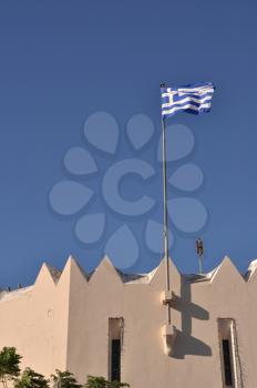 Royalty Free Photo of the Flag of Greece on a Kos Town Building