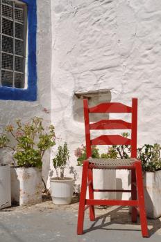 Royalty Free Photo of a Greek House With a Red Chair in Zia Village (Kos), Greece