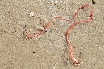 Red rope in the sand