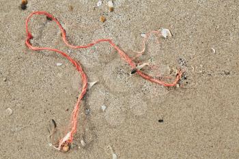Red rope in the sand