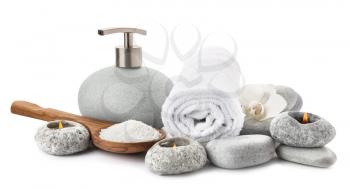 Spa composition with candles, toiletries and clean towel on white background�