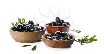 Bowls with black olives on white background�