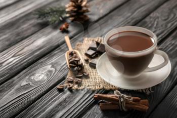Cup of tasty hot chocolate on dark wooden table�