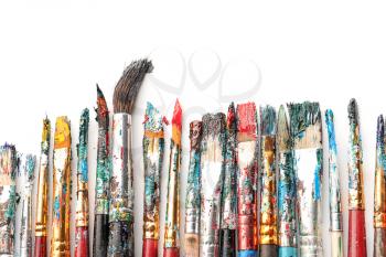 Dirty paint brushes on white background�