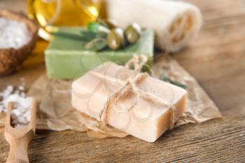 Bar of natural soap with olive extract on table�