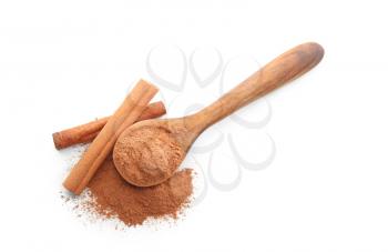 Spoon with cinnamon powder and sticks on white background�