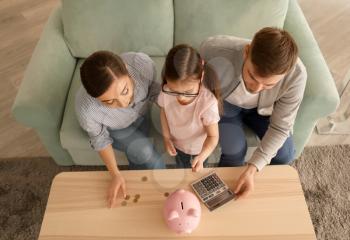 Family counting money indoors. Money savings concept�
