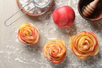 Raw rose shaped apple pastry on table�