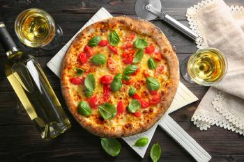 Delicious pizza with wine on table�