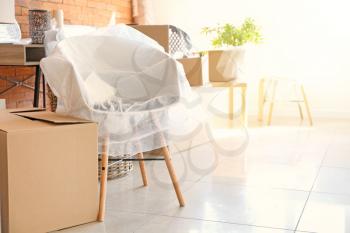 Interior items and packed carton boxes in room. Moving house concept�