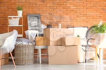Carton boxes and interior items in room. Moving house concept�