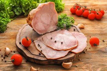 Composition with delicious sliced ham on wooden table�