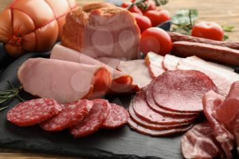 Assortment of delicious deli meats on slate plate�