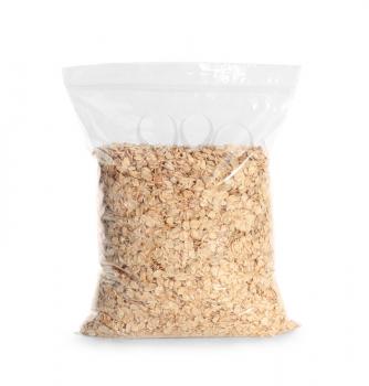 Package with raw oatmeal on white background�