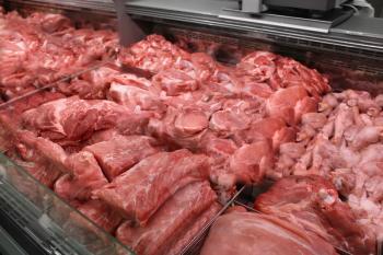 Refrigerated display case with fresh meat in butcher shop�