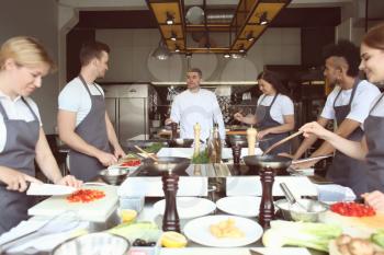 Chef and group of young people during cooking classes�