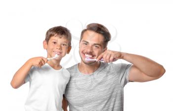 Little boy and his father brushing teeth on white background�
