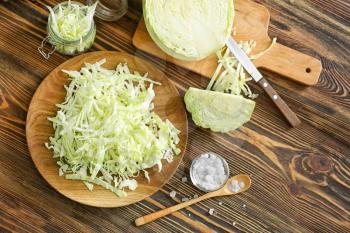 Composition with cut cabbage on wooden table�