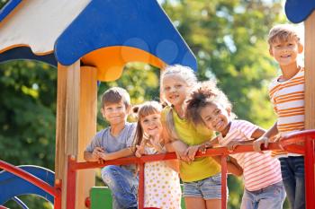 Cute little children having fun on playground outdoors�