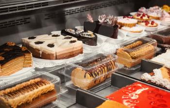 Refrigerated display case with delicious desserts in supermarket�