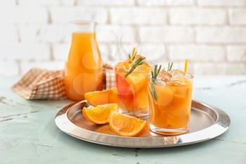 Glasses of tasty orange cocktail on tray�