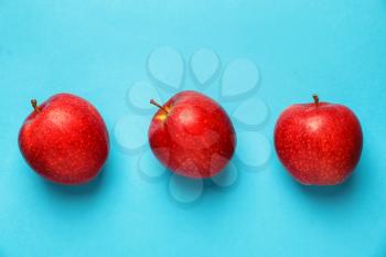 Ripe red apples on color background�